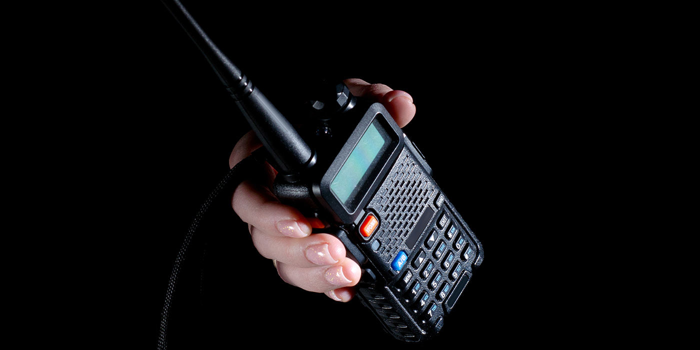 Walkie-talkie security in hand on white background isolation